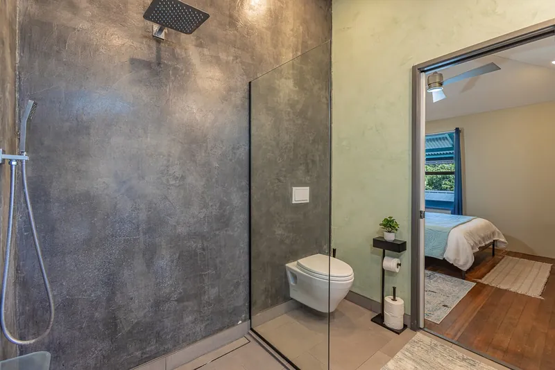 En suite bathroom in primary w/pocket door for privacy — Historic 2BR Condo, Wailuku